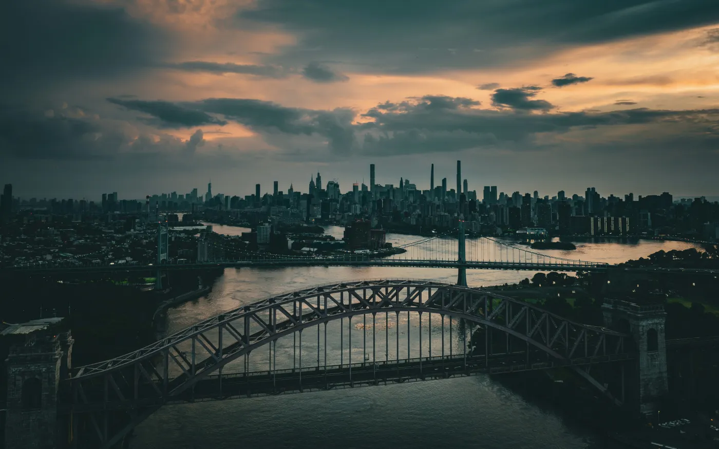 a bridge over a river with a city in the background by Venti Views courtesy of Unsplash.